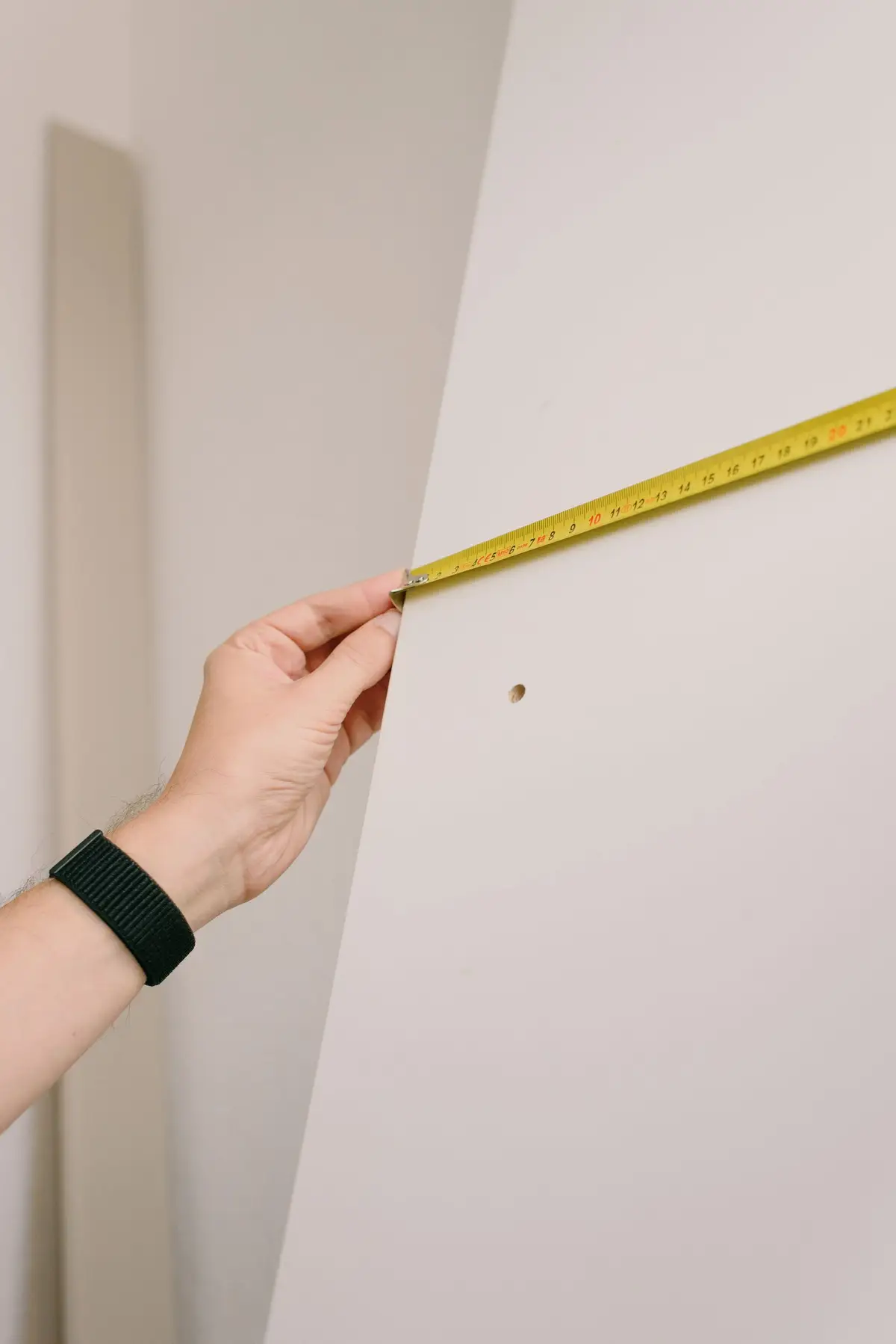 Measuring tape held against a wall (Measure your bathroom for a walk-in tub)